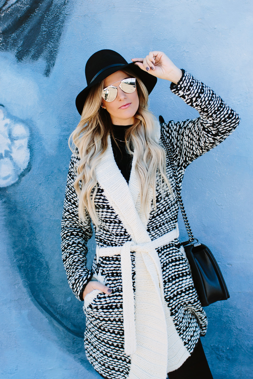 dash of darling caitlin lindquist woven wrap black and white sweater winter outfit inspiration