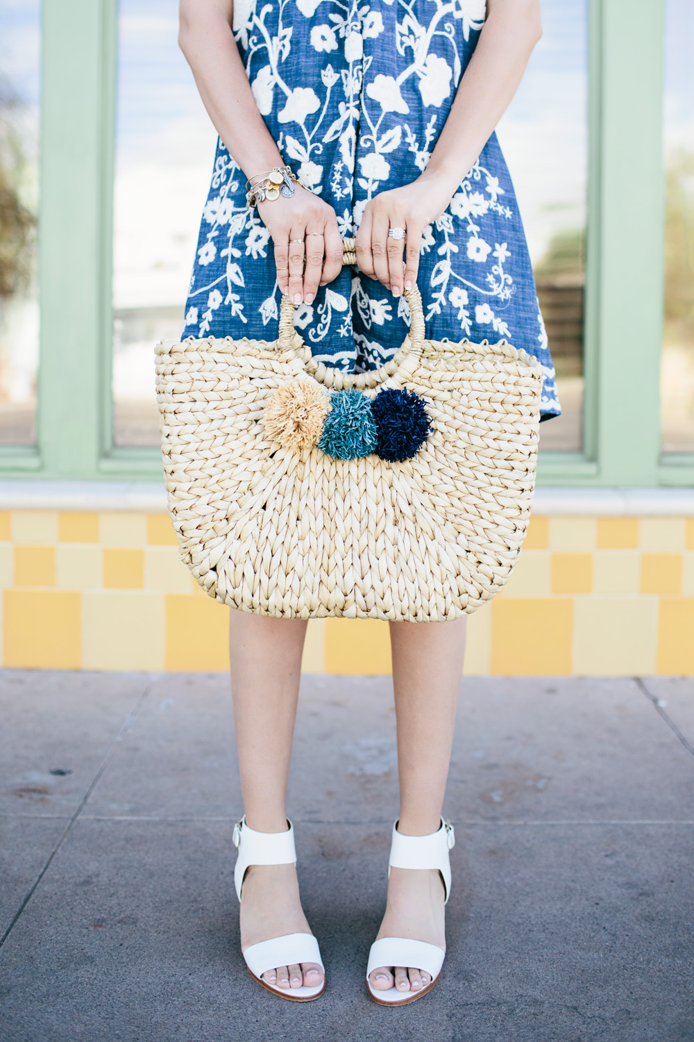 embroidered denim chambray dress pom straw tote spring outfit inspiration