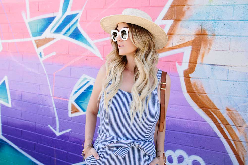 Dash of Darling wears a straw boater hat by Hat Attack with a stripe madewell jumpsuit that ties at the waist