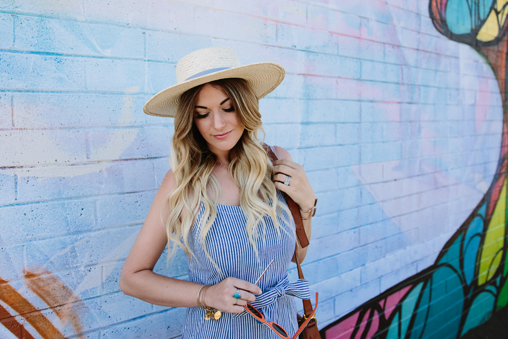 Dash of Darling styles a madewell stripe jumpsuit with a straw boater hat by Hat Attack and a Chloe cross body bag.