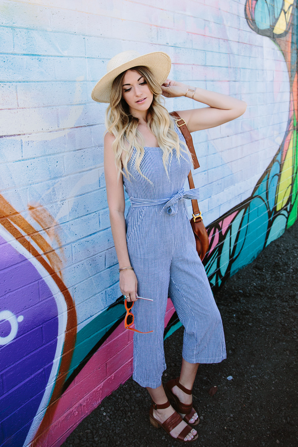dash of darling styles a madewell stripe jumpsuit with cognac leather sandals, a chloe cross body bag and a straw boater hat for summer.