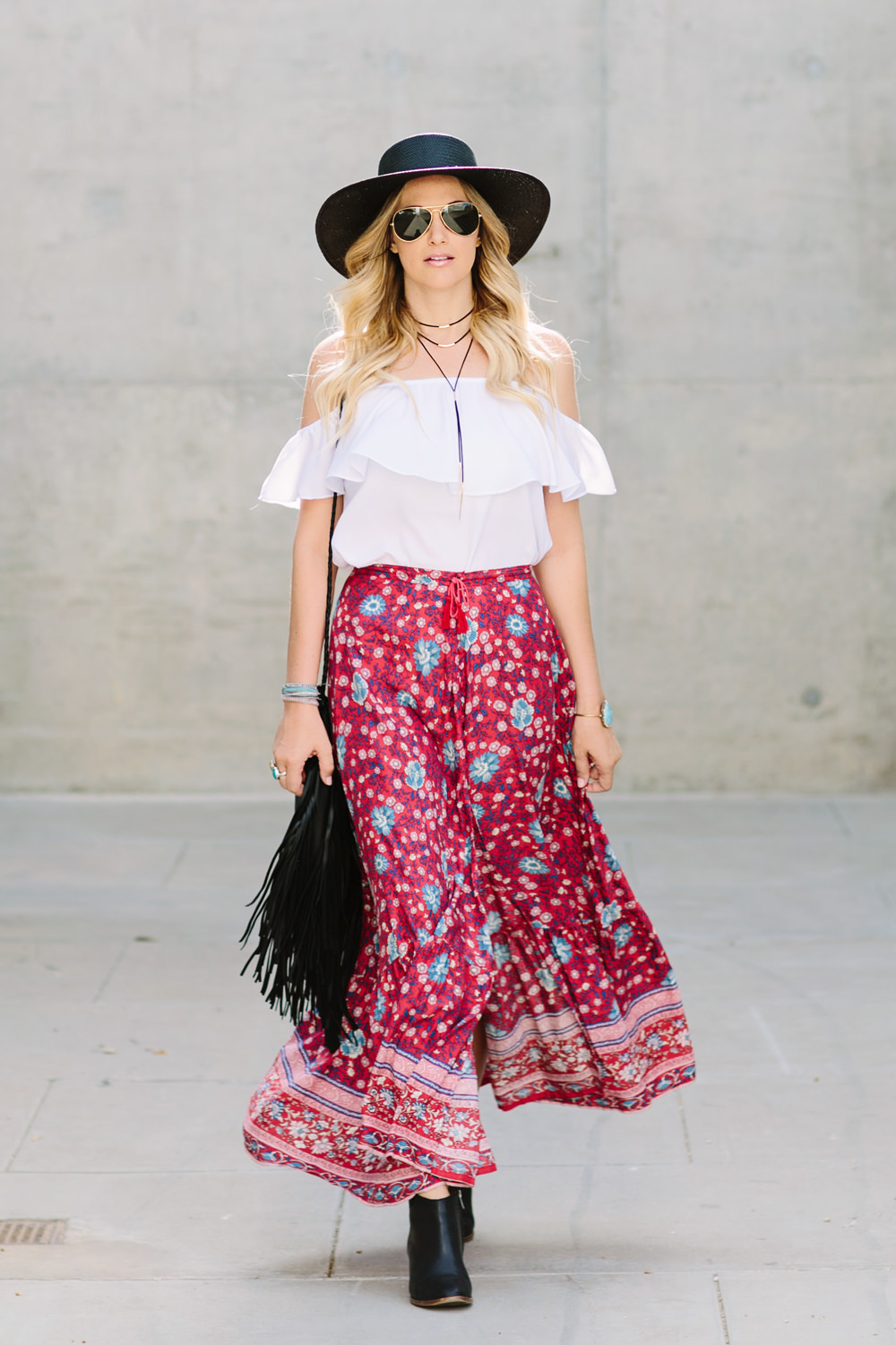 Dash of Darling styles a Spell Designs folktown printed maxi skirt with a Show me Your Mumu off shoulder Chiquita top and a Jennifer Haley fringe bag with a Janessa Leone Jalk fedora.