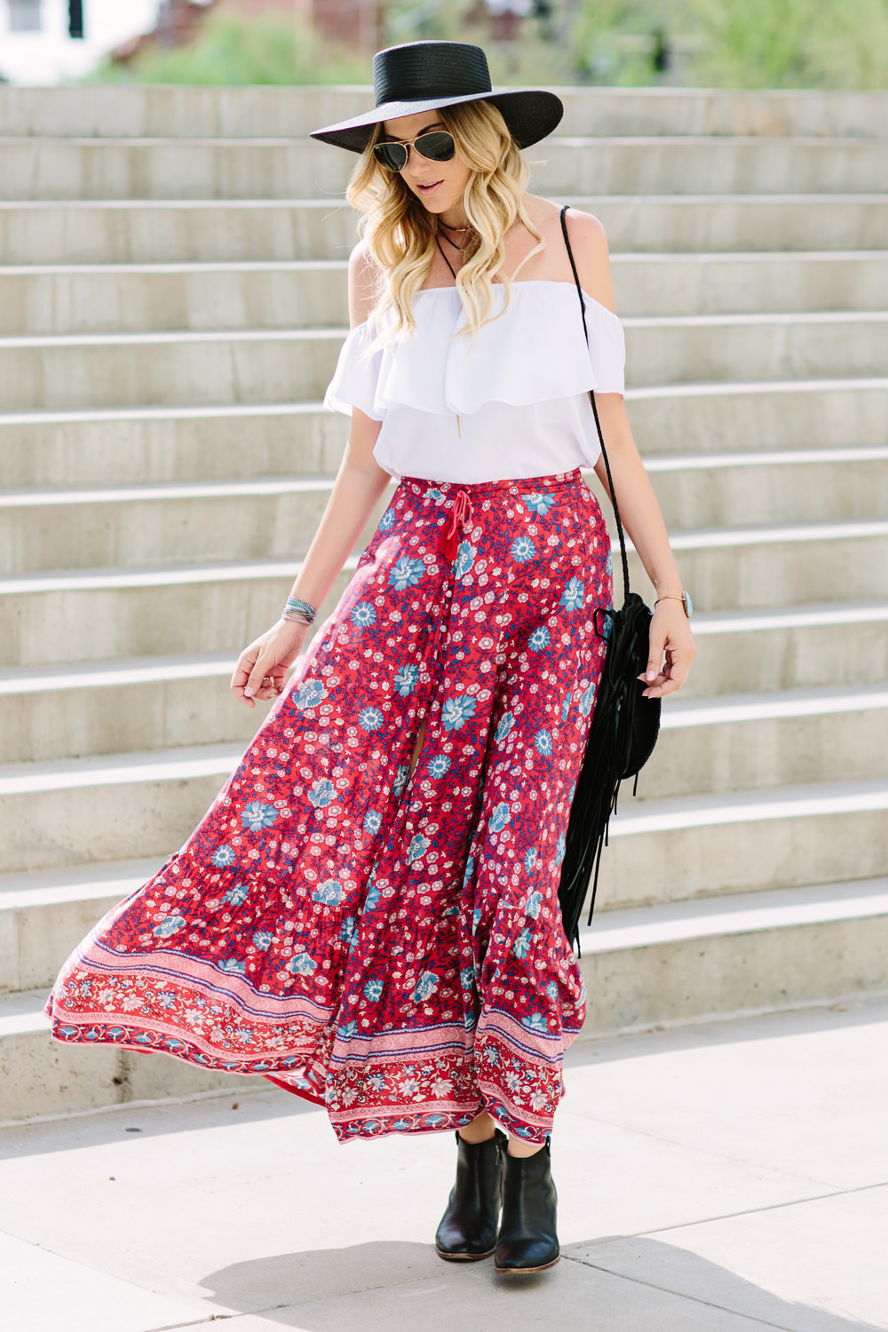 Dash of Darling wears a Spell Designs bohemian maxi skirt with a Show Me Your Mumu Off Shoulder top and a Jennifer Haley fringe bag.