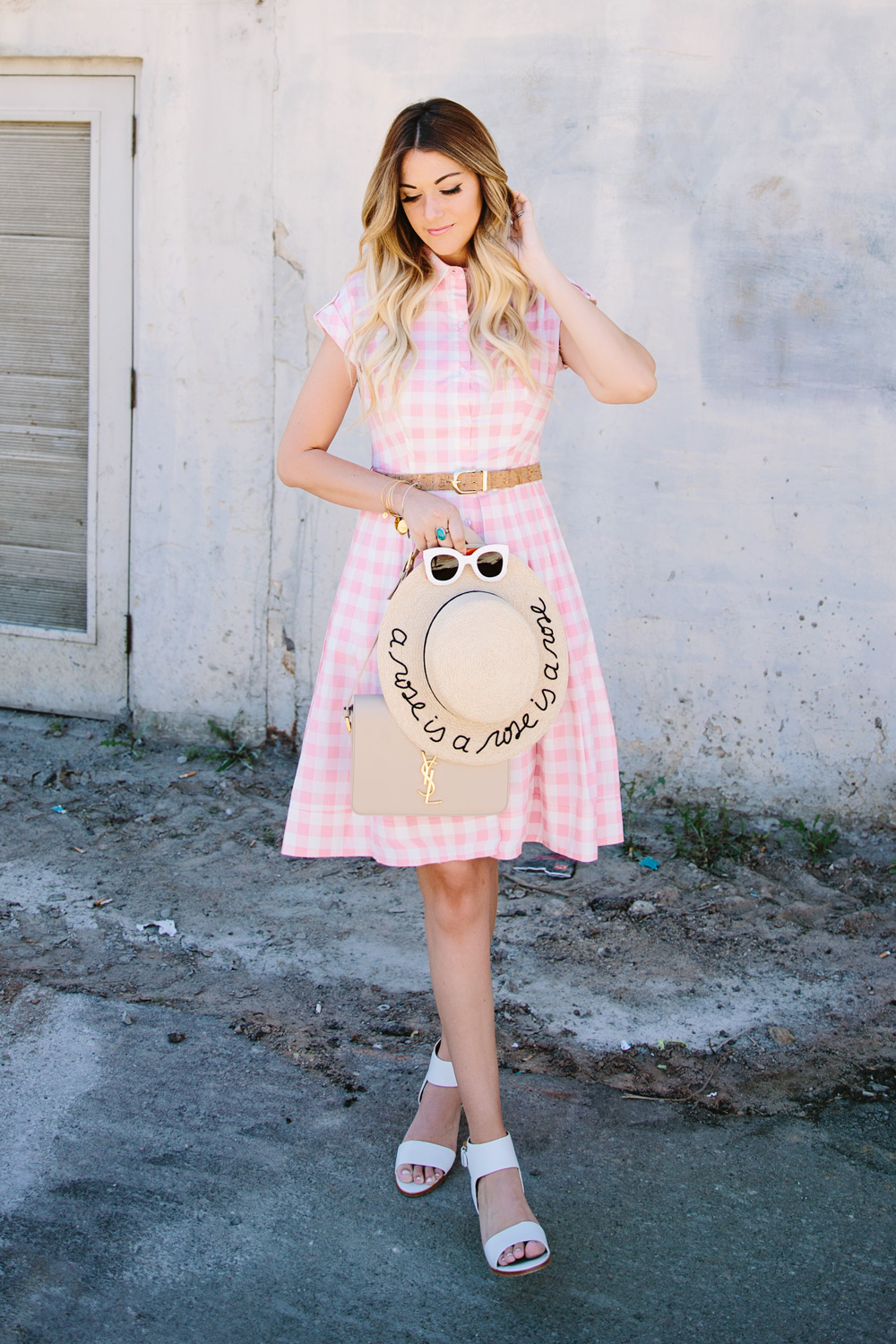 Dash of Darling styles an Eliza J gingham pink checkered poplin dress from Nordstrom with an Eugenia Kim straw boater hat, white Joie sandals and white Celine sunglasses for the perfect summer outfit.
