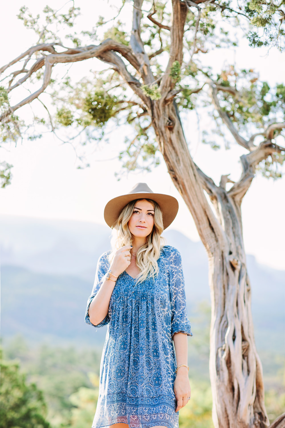 Caitlin Lindquist of the travel blog Dash of Darling styles a summer outfit consisting of a Joie silk shift dress with a Hat Attack felt fedora while exploring the desert in Sedona.