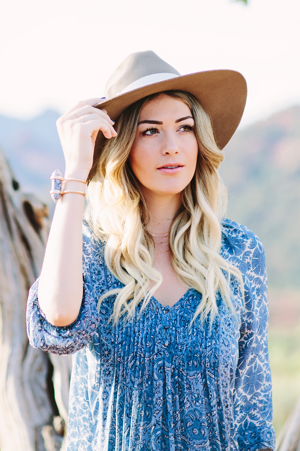 Caitlin Lindquist of the travel blog Dash of Darling styles a summer outfit consisting of a Joie silk shift dress with a Hat Attack felt fedora while exploring the desert in Sedona.