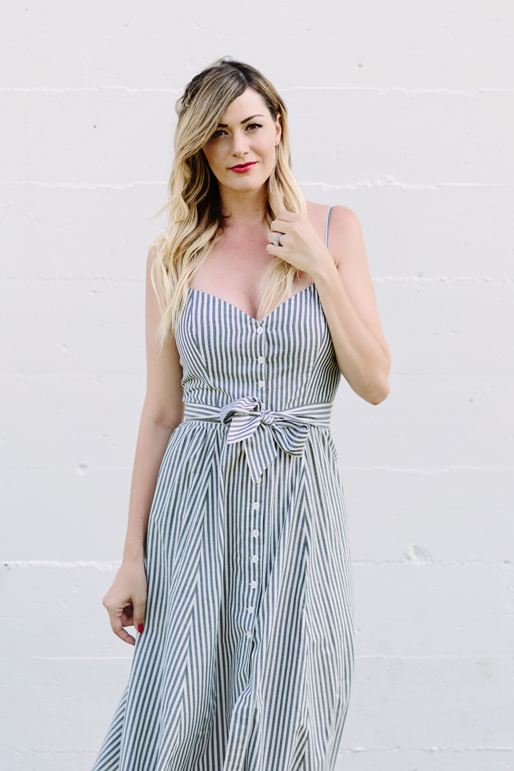 Caitlin Lindquist of Dash of Darling styles a stripe button down reformation dress that is the perfect feminine summer outfit  for the fourth of july.