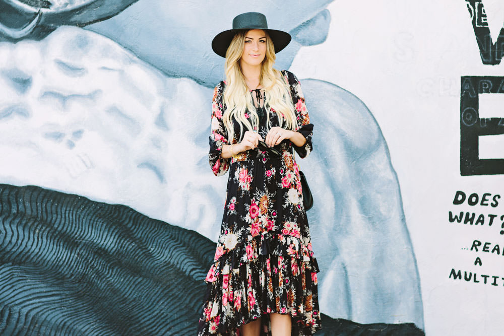 Caitlin Lindquist of the fashion blog Dash of Darling styles a Spell Designs Jagger bohemian floral dress with Acne boots, a Janessa Leone boater hat, a Chloe Drew bag and Dior sunglasses for a summer outfit.