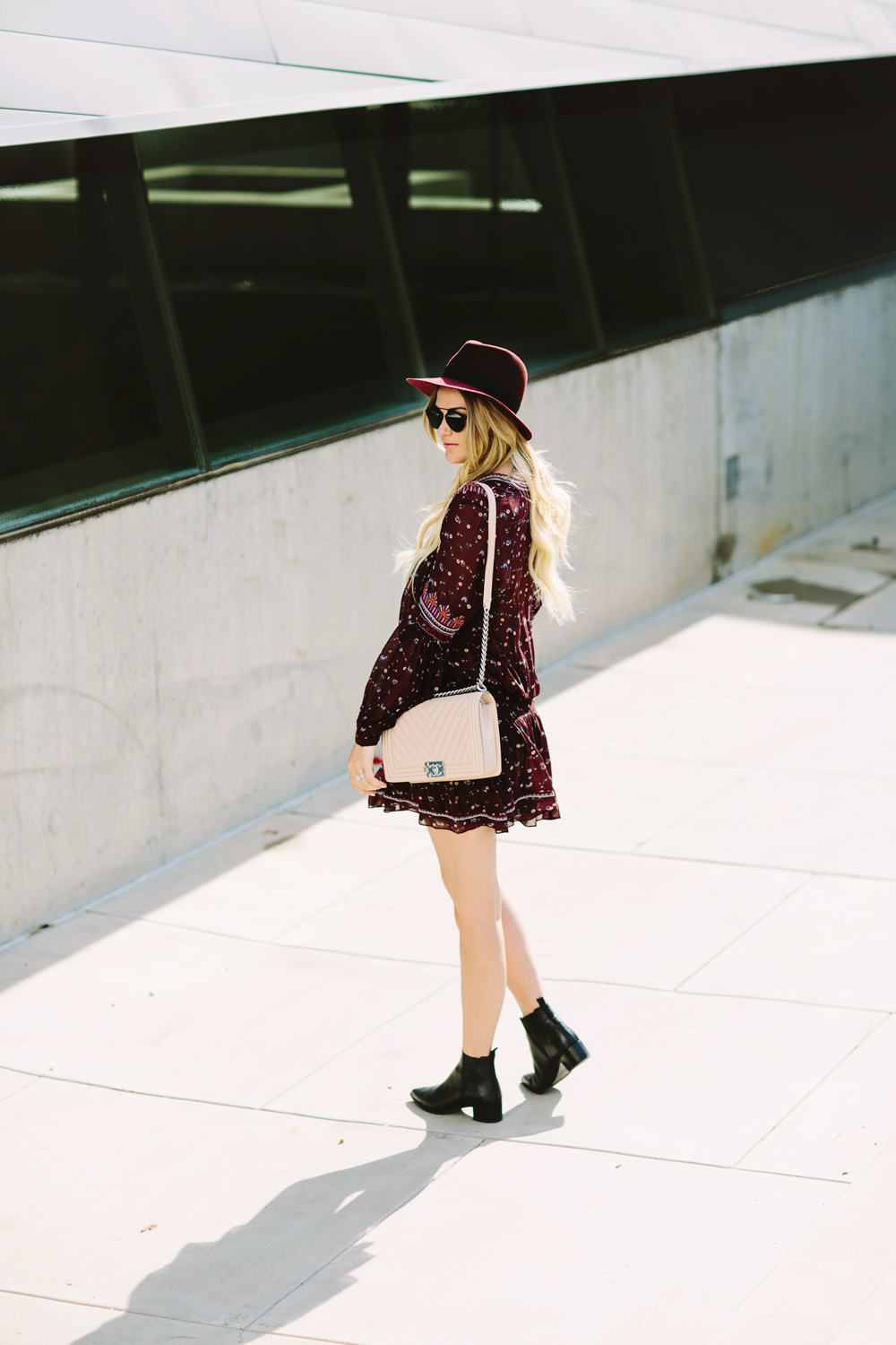 Caitlin Lindquist of the Arizona fashion blog styles an Ulla Johnson sheer floral mini dress with a Rag and Bone hat, Acne boots and Chanel chevron boy bag.