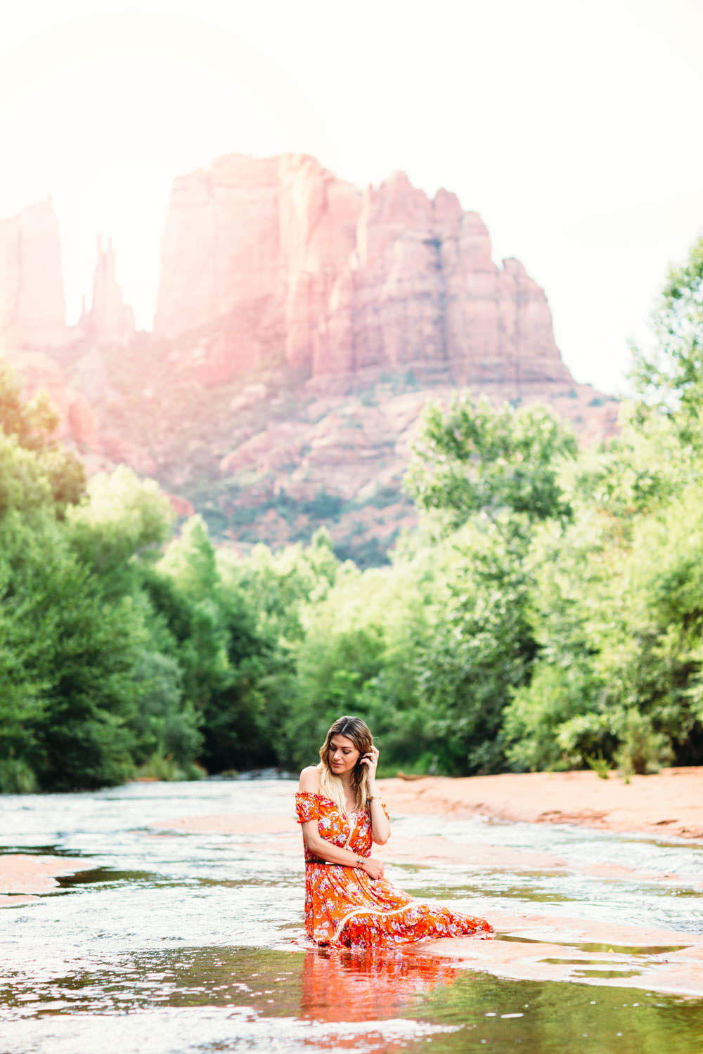 Dash of Darling styles an off shoulder floral dress by Spell Designs while exploring Cathedral Rock in Sedona Arizona