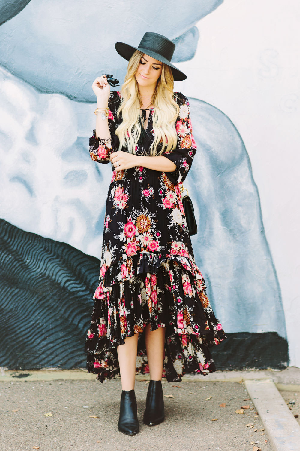 Caitlin Lindquist of the fashion blog Dash of Darling styles a Spell Designs Jagger bohemian floral dress with Acne boots, a Janessa Leone boater hat, a Chloe Drew bag and Dior sunglasses for a summer outfit.