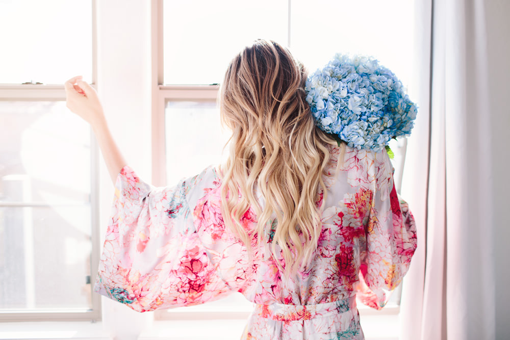 Dash of Darling lounges at home in her Natori satin floral robe from Her Room.