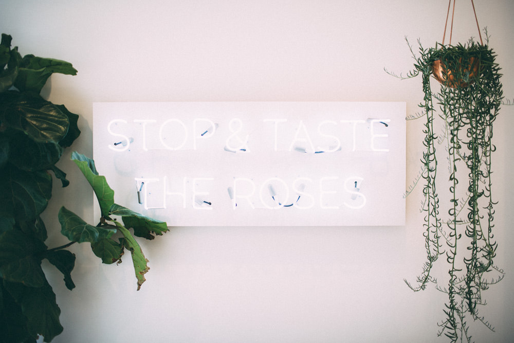 stop and taste the roses neon sign in teaspressa, a tea shop and cake house scottsdale arizona