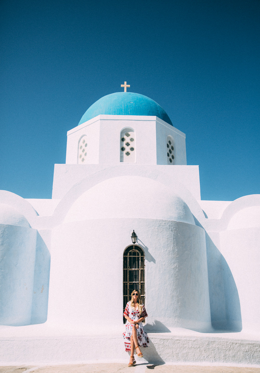 Dash of Darling shares her travels to Santorini, Greece with Royal Caribbean Cruises while wearing a Reverse dress from Revolve Clothing.