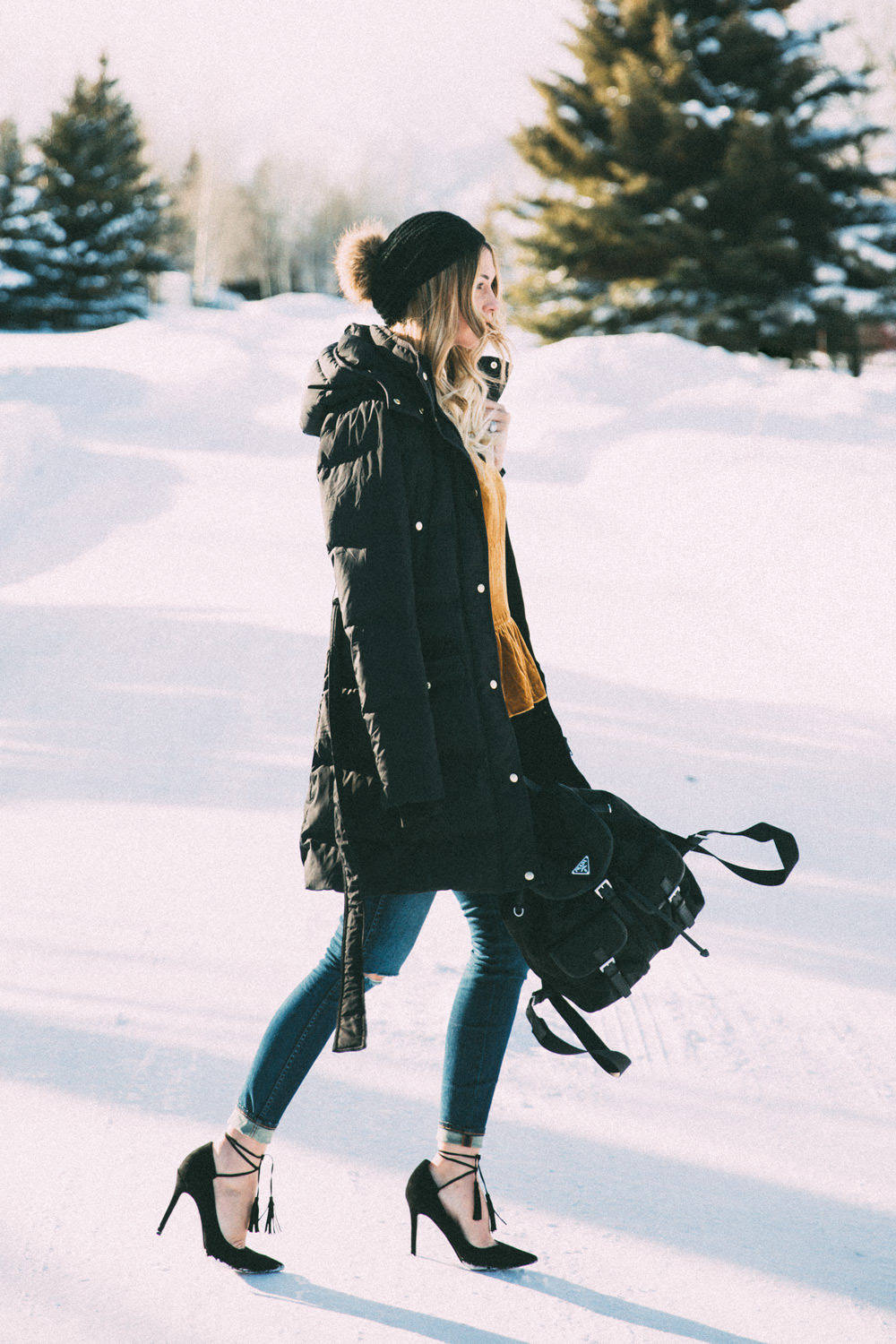 Caitlin Lindquist of Dash of Darling shares a winter outfit in Jackson Wyoming wearing a velvet camisole tank top and madewell ripped high rise skinny denim.