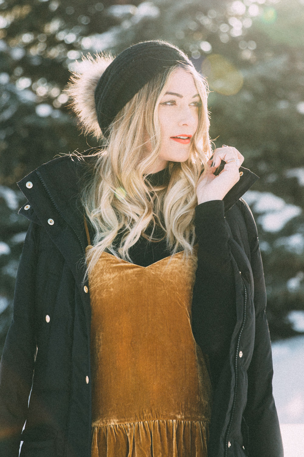 Caitlin Lindquist of Dash of Darling shares a winter outfit in Jackson Wyoming wearing a velvet camisole tank top and madewell ripped high rise skinny denim.