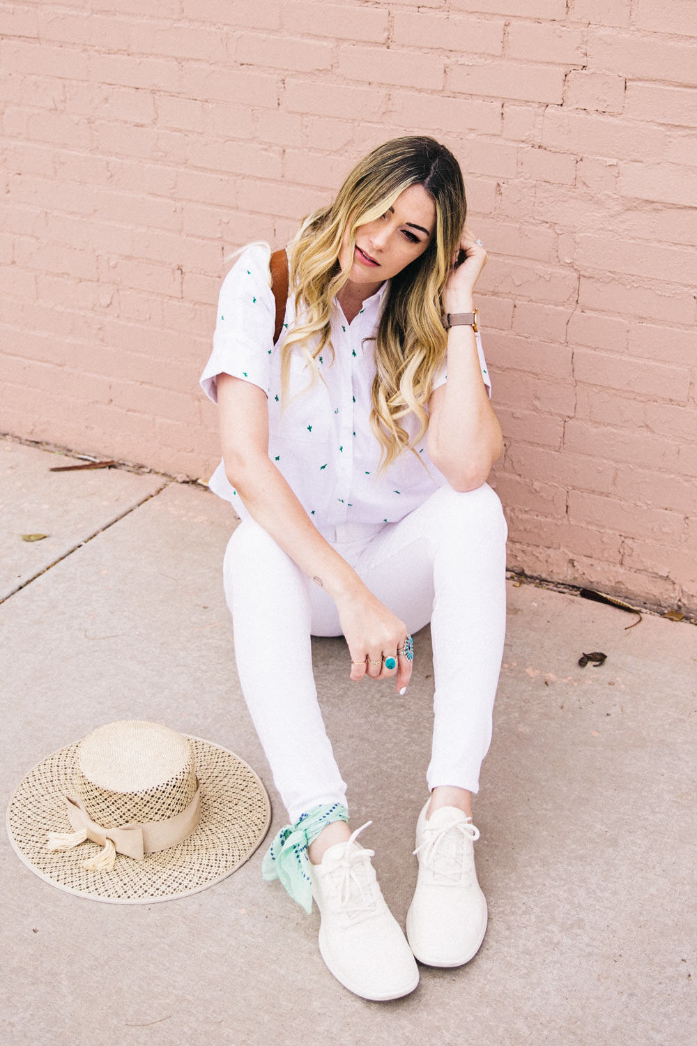 Caitlin Lindquist of Dash of Darling shares an all white outfit for Spring with AllBirds wool runners, white madewell denim, a cactus shirt and a boater hat.
