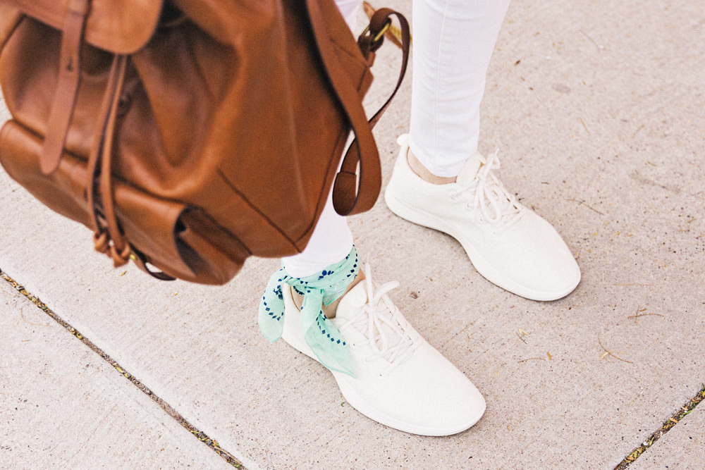 Caitlin Lindquist of Dash of Darling shares an all white outfit for Spring with AllBirds wool runners, white madewell denim, a cactus shirt and a boater hat.