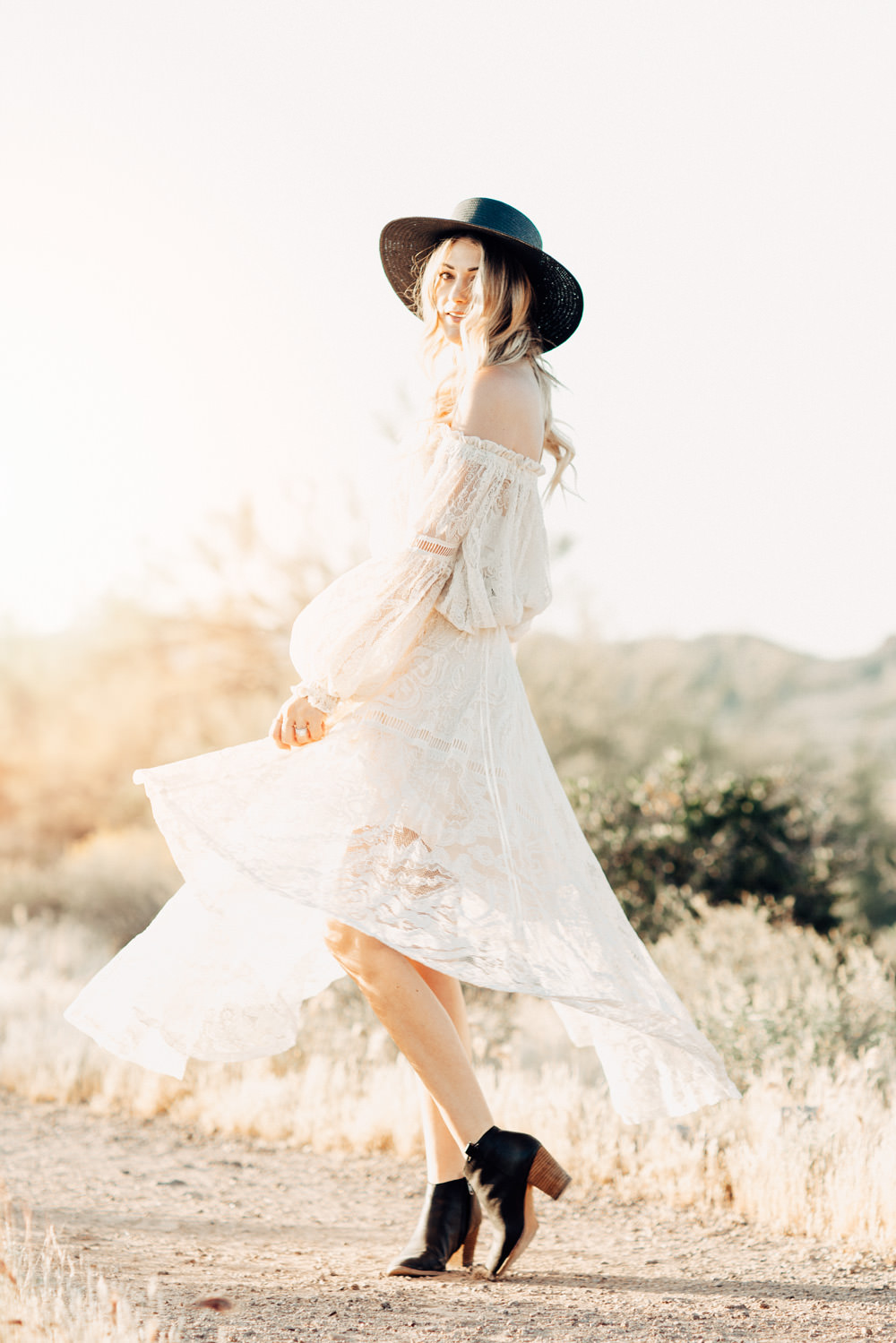Caitlin Lindquist of the Arizona fashion blog Dash of Darling wears a Spell Designs white lace off shoulder top and skirt in the desert