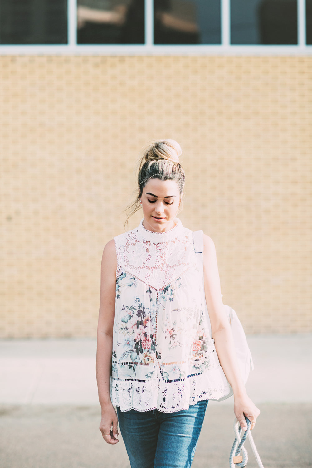 Caitlin Lindquist of the Arizona fashion blog Dash of Darling shares a casual outfit wearing a floral top and white backpack.