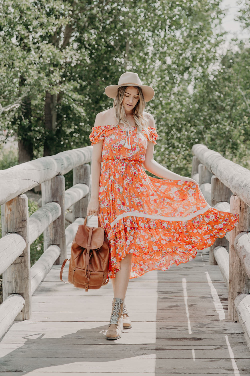 Dash of Darling shares an off shoulder orange dress in Jackson Hole, Wyoming while 21 weeks pregnant.